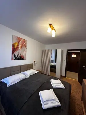 a bedroom with a bed with two towels on it at Apartment 35 Mountain Lodge Pamporovo in Pamporovo