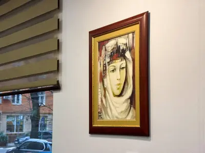 a painting of a woman hanging on a wall at Central 2BR Near Vitosha - Calm, Spacious Stay in Sofia