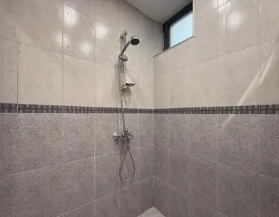 a bathroom with a shower with a shower head at Central 2BR Near Vitosha - Calm, Spacious Stay in Sofia
