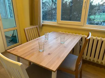 a wooden table with glasses on it in a room with windows at Flat in Darvenitsa near Church St George the Victorious in Sofia