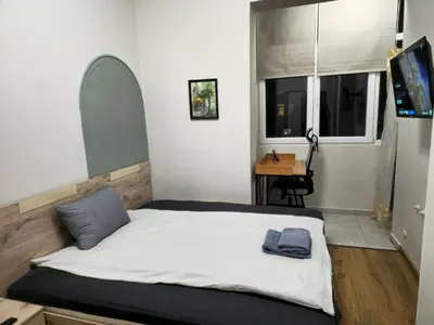a bedroom with a bed and a desk in it at 4BR Central Retreat in Sofia