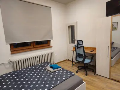 a bedroom with a bed and a desk and a chair at 4BR Central Retreat in Sofia