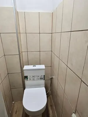 a bathroom with a white toilet in a room at 4BR Central Retreat in Sofia