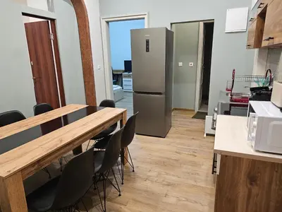 a kitchen with a table and a refrigerator at 4BR Central Retreat in Sofia