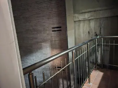 a staircase in a building with a brick wall at 4BR Central Retreat in Sofia