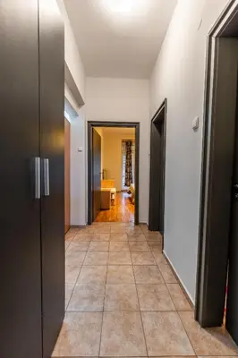 a hallway with doors and a tile floor at Gurko Finest in Sofia