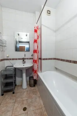 a bathroom with a bath tub and a sink at Gurko Finest in Sofia