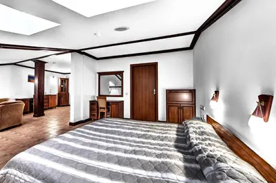 a bedroom with a large bed in a room at Спа Хотел Орфей in Devin
