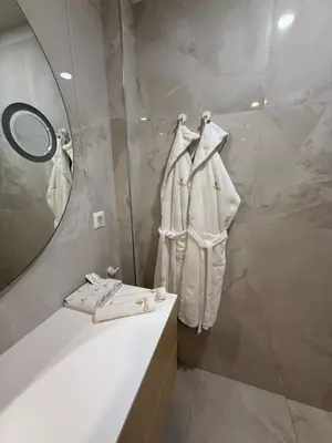 a bathroom with a mirror and a sink at Спа Хотел Орфей in Devin
