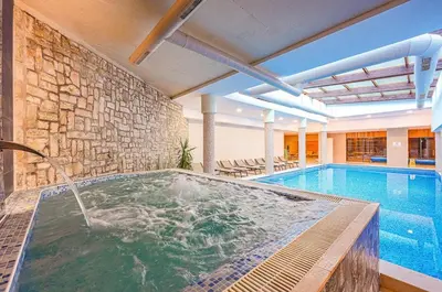 a swimming pool with a hot tub in a building at Predela 2 Aparthotel Ski & Spa 200m from slopes in Bansko