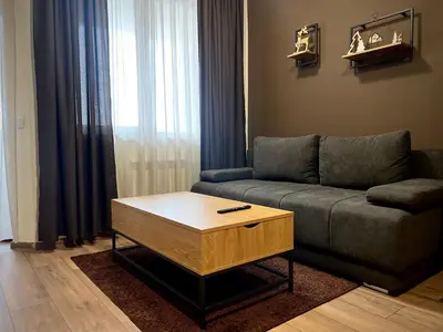 a living room with a couch and a coffee table at Elite Apartments Flora Residence in Borovets
