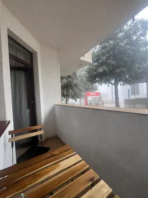 a balcony with a wooden bench and a window at Elite Apartments Flora Residence in Borovets