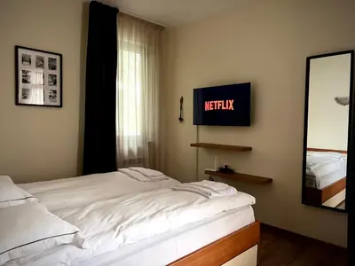a bedroom with a bed and a television on the wall at Elite Apartments Flora Residence in Borovets