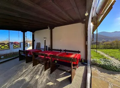 a dining room with red tables and a view at RhodoNest in Kara Agach