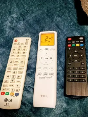 three remote controls sitting next to each other on a table at GuestHouse5 KARMA369 in Plovdiv