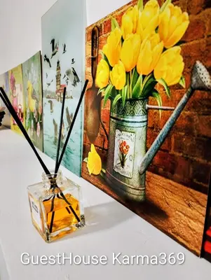 a table with a vase with yellow flowers in it at GuestHouse5 KARMA369 in Plovdiv