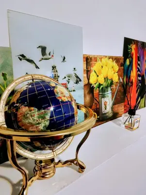 a globe on a stand on a table with flowers at GuestHouse5 KARMA369 in Plovdiv