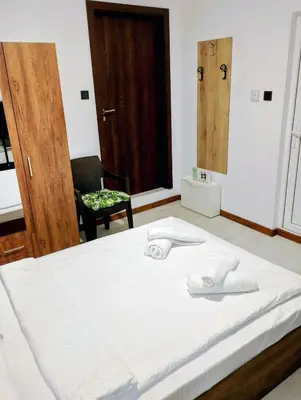a bed with two white towels on top of it at GuestHouse1 Karma369 in Plovdiv