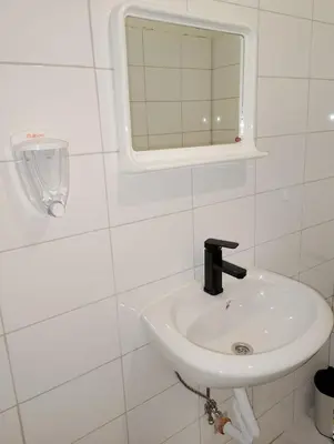 a white bathroom with a sink and a mirror at GuestHouse1 Karma369 in Plovdiv