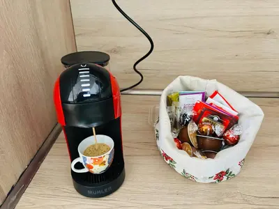 a coffee maker and a cup of coffee on a counter at Борово ухание Говедарци Pine scent Govedartsi in Govedartsi