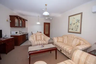 a living room with two couches and a table at Ametist - Comfort by the Gondola Lift in Bansko