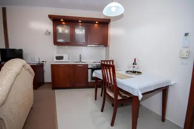 a kitchen with a table and a kitchen with a sink at Ametist - Comfort by the Gondola Lift in Bansko