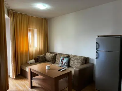 a living room with a couch and a table at Lucky Star Bansko Next to the Ski Lift with FREE Parking in Bansko