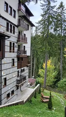 a building with balconies on the side of it at Apartments Pamporovo, Green life apartment hotel in Pamporovo