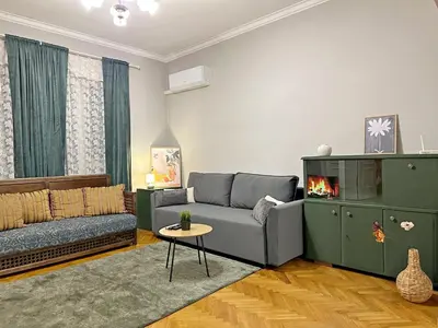 a living room with a couch and a fireplace at Elegant 2BDR Apt for groups and family - Fast Wi-Fi in Sofia