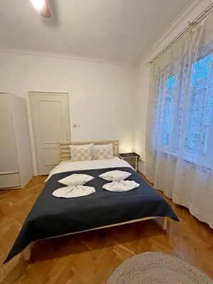 a bedroom with a large bed with towels on it at Elegant 2BDR Apt for groups and family - Fast Wi-Fi in Sofia
