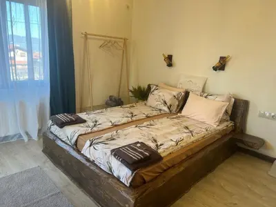 a bed in a room with blankets on it at Rilski Chardak in Sapareva Banya