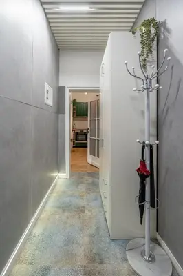 a hallway with a white wall with a plant at NG- apartments in Sofia