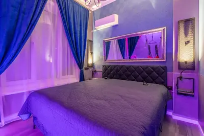 a purple bedroom with a bed with purple curtains at NG- apartments in Sofia