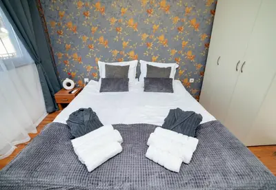 a bedroom with a bed with pillows on it at Pirin SkiLift Apartment - Cozy & Modern App in Bansko, 100 m to the Gondola in Bansko