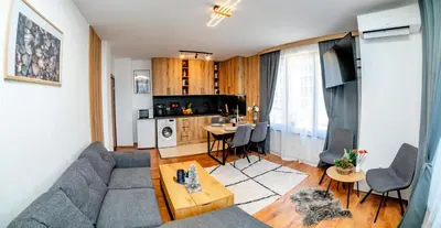 a living room with a couch and a table at Pirin SkiLift Apartment - Cozy & Modern App in Bansko, 100 m to the Gondola in Bansko
