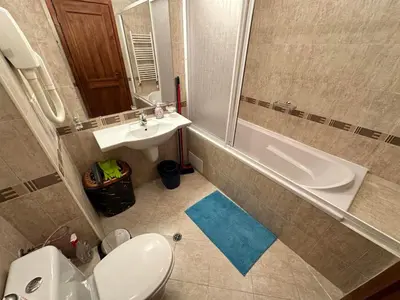 a bathroom with a toilet and a sink and a shower at St Ivan Rilski spacious apartment in Bansko