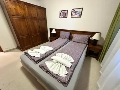 a bedroom with a bed with towels on it at St Ivan Rilski spacious apartment in Bansko