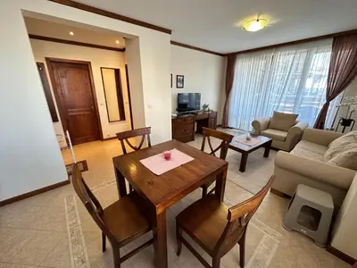 a living room with a table and a couch at St Ivan Rilski spacious apartment in Bansko