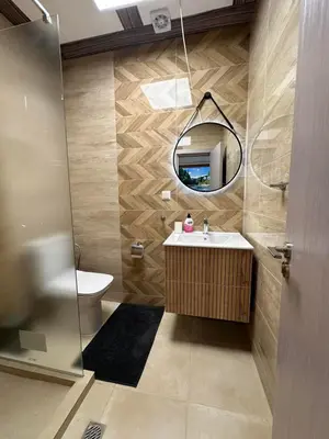 a bathroom with a sink and a mirror at Apart-Hotel Crow Bansko 3 in Bansko