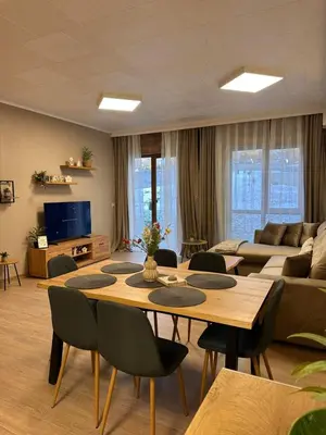 a living room with a table and a couch at Apart-Hotel Crow Bansko 3 in Bansko