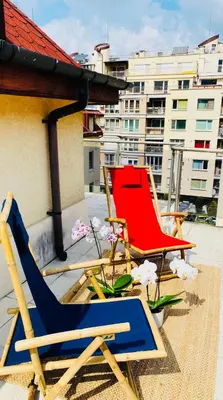 a couple of chairs sitting on a roof at Bulgaria Mall Flat in Sofia