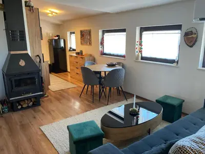 a living room with a couch and a table at Студио за гости Петрови in Bansko