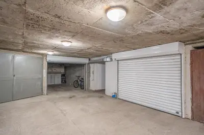 an empty garage with a garage door in a building at Free parking 1BR Tokuda Lozenets in Sofia