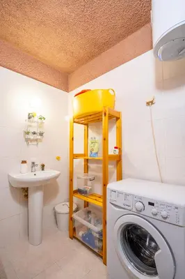 a bathroom with a washing machine and a sink at Free parking 1BR Tokuda Lozenets in Sofia