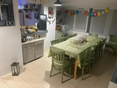 a kitchen with a table and chairs in a kitchen at Relyovo Lodge in Relyovo