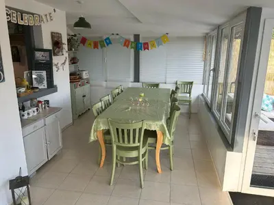 a dining room with a table and chairs in a kitchen at Relyovo Lodge in Relyovo