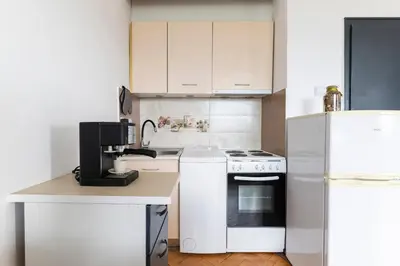 a kitchen with white appliances and a white refrigerator at 2-Bedroom Apartment near Tokuda Hospital & Paradise Mall in Sofia