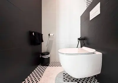 a white toilet in a bathroom with a black wall at View, Location, High End Interior, Lift, AC in Sofia