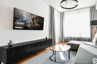 a living room with a tv on a white wall at View, Location, High End Interior, Lift, AC in Sofia