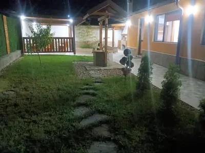 a backyard at night with a fountain in the yard at Пътепис in Bratsigovo